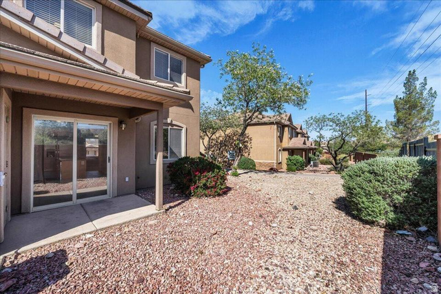 3155 South Hidden Dr Street, Unit 248 St. George, UT 84790 - Photo 16 of 24 Rear exterior featuring a covered patio with concrete flooring and sliding glass door