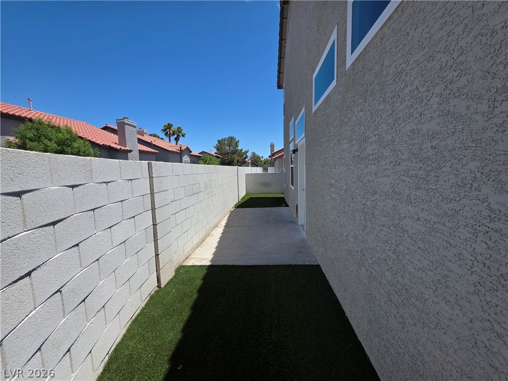 2275 Ramsgate Drive Henderson, NV 89074 - Photo 10 of 84 A well-maintained side yard offers a neat concrete path and artificial turf.