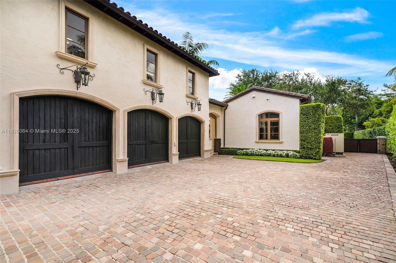 10101 Southwest 60th Court Pinecrest, FL 33156 - Photo 14 of 98 a front view of a house with a yard and garage
