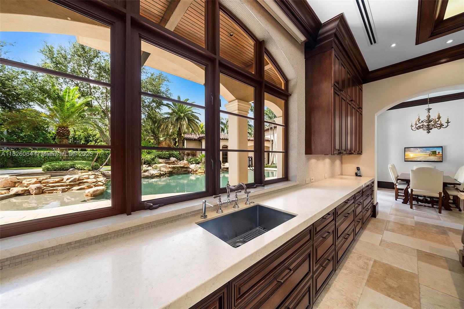 10101 Southwest 60th Court Pinecrest, FL 33156 - Photo 26 of 98 a kitchen with stainless steel appliances a sink and a large window