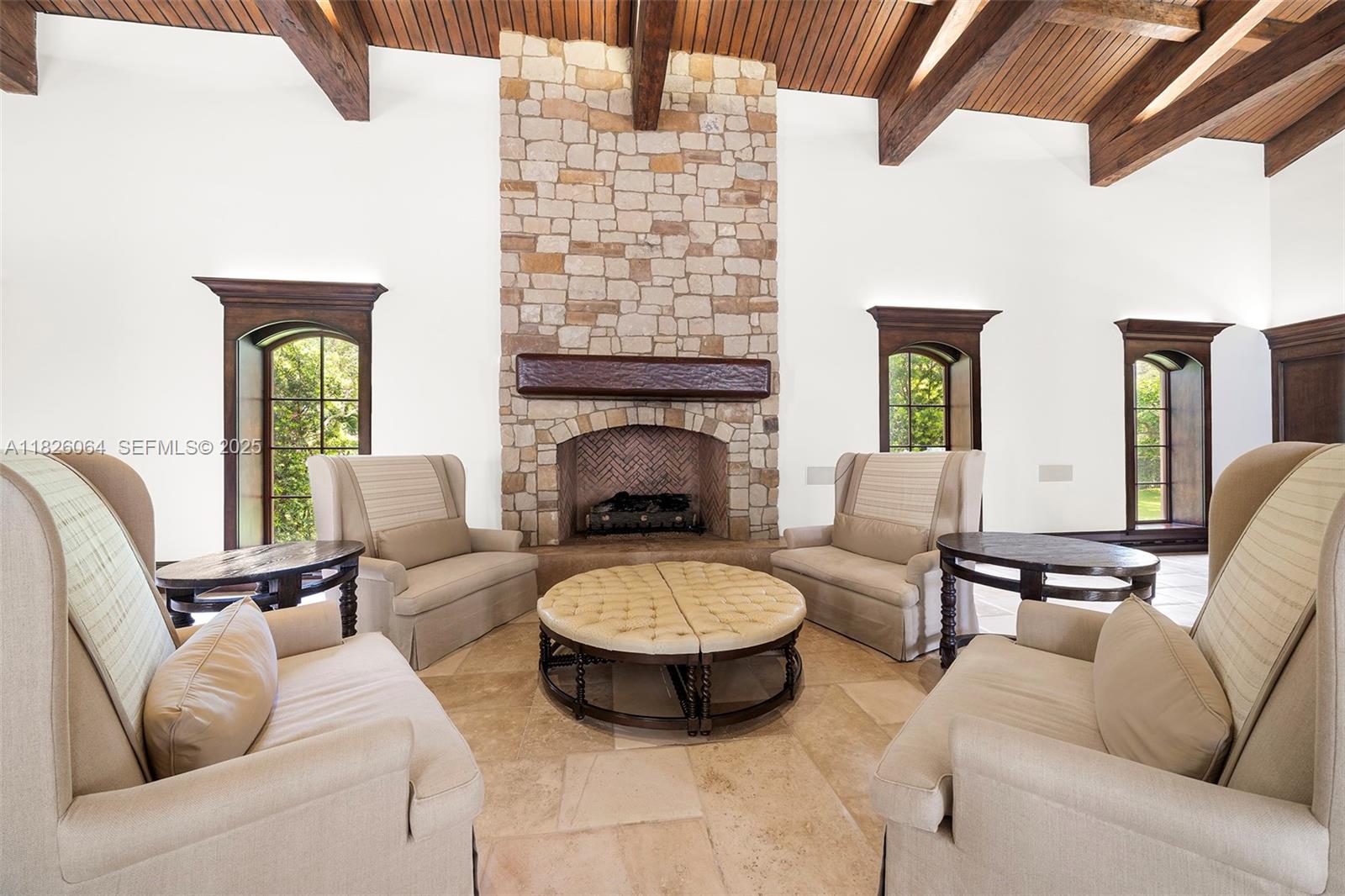 10101 Southwest 60th Court Pinecrest, FL 33156 - Photo 30 of 98 a living room with furniture a fireplace and a large window