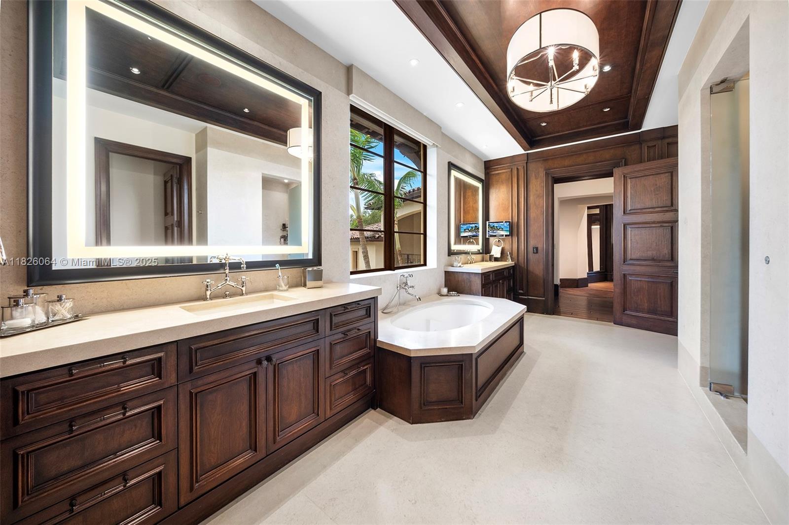 10101 Southwest 60th Court Pinecrest, FL 33156 - Photo 44 of 98 a bathroom with a sink a mirror and a large window