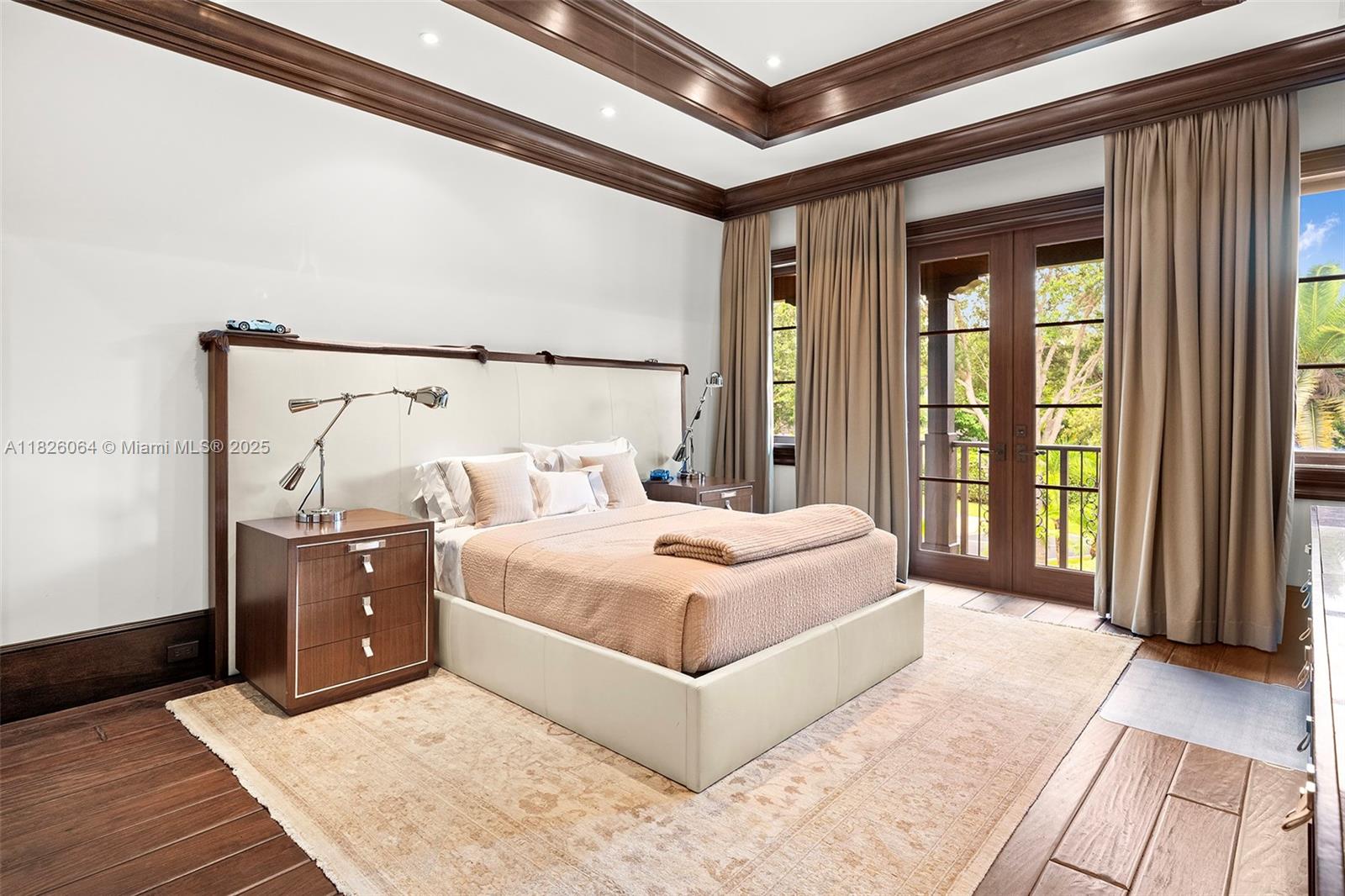 10101 Southwest 60th Court Pinecrest, FL 33156 - Photo 50 of 98 a bedroom with a large bed and a large window