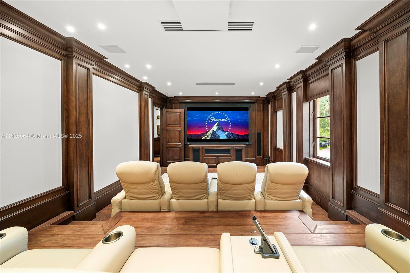 10101 Southwest 60th Court Pinecrest, FL 33156 - Photo 55 of 98 a living room with furniture a flat screen tv and a large window