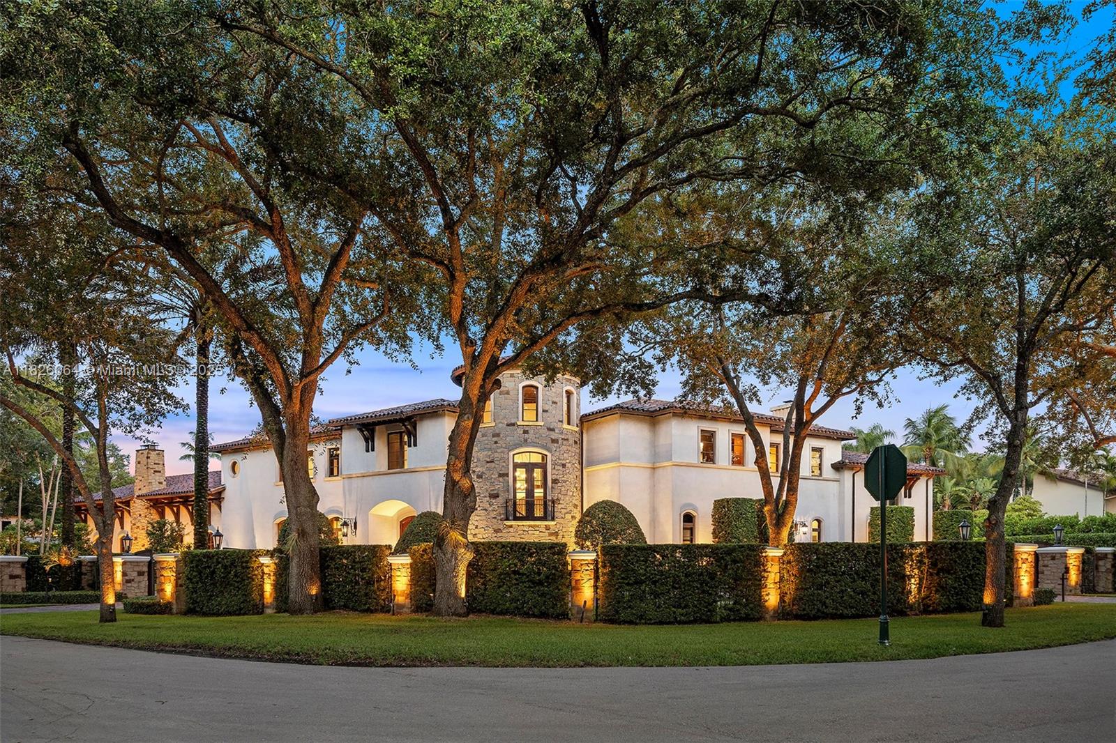 10101 Southwest 60th Court Pinecrest, FL 33156 - Photo 6 of 98 a front view of a house with a yard