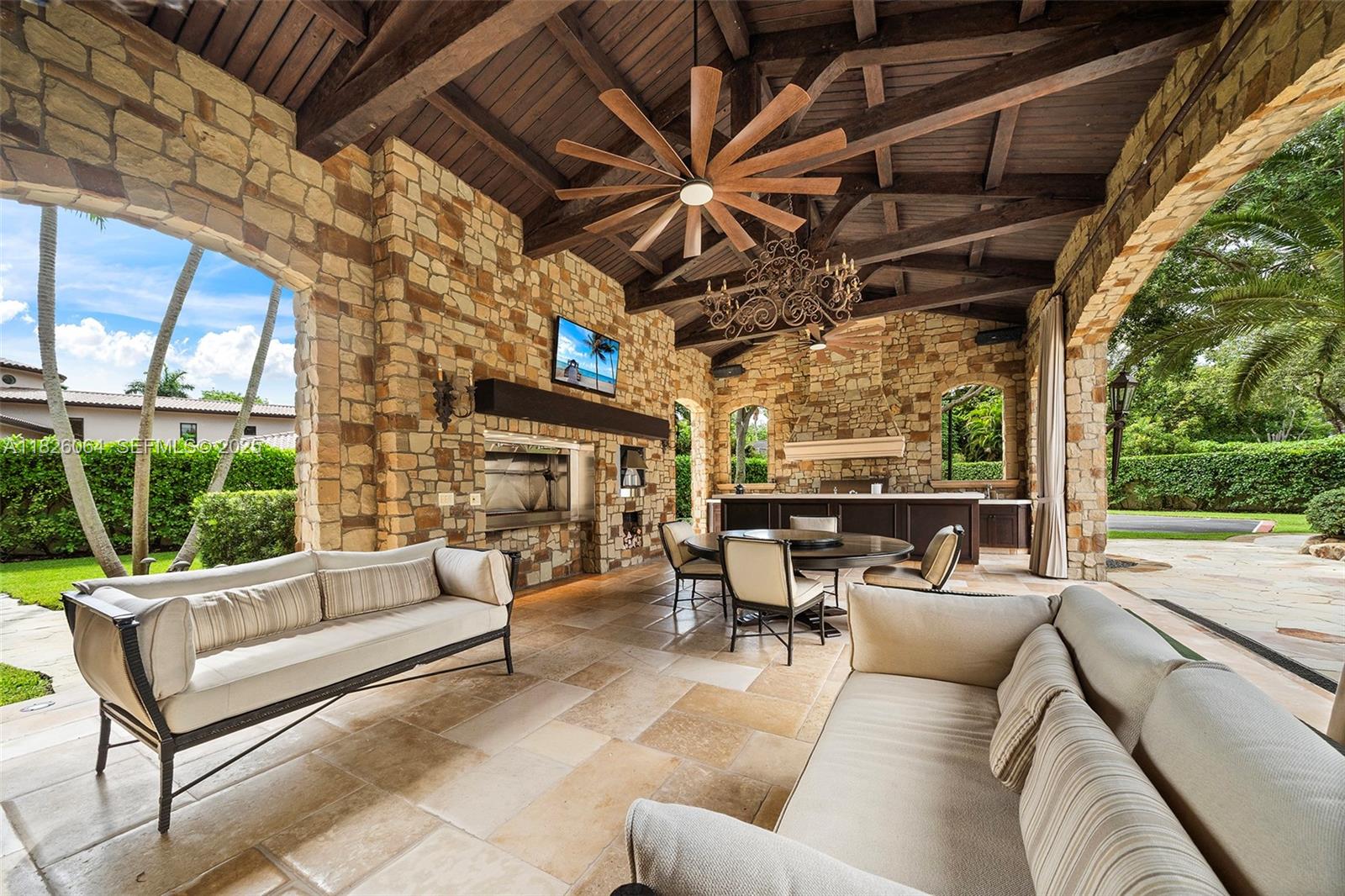 10101 Southwest 60th Court Pinecrest, FL 33156 - Photo 66 of 98 a outdoor living space with patio furniture and a garden