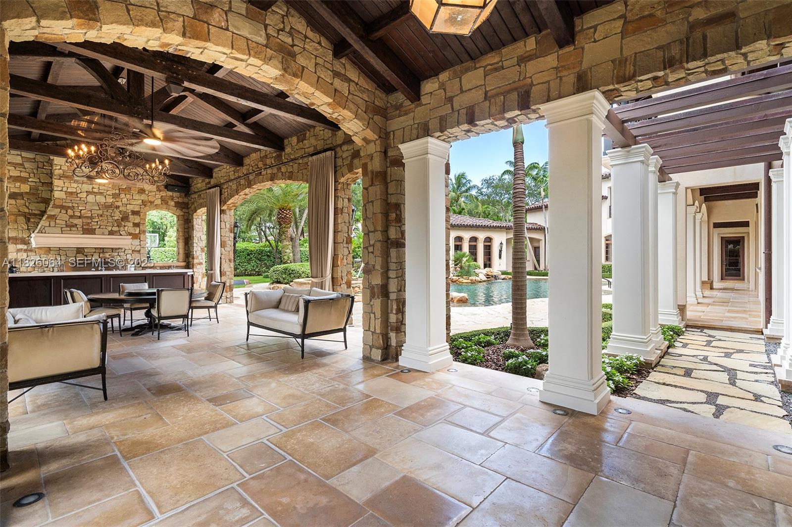 10101 Southwest 60th Court Pinecrest, FL 33156 - Photo 69 of 98 a building outdoor space with patio furniture and potted plants
