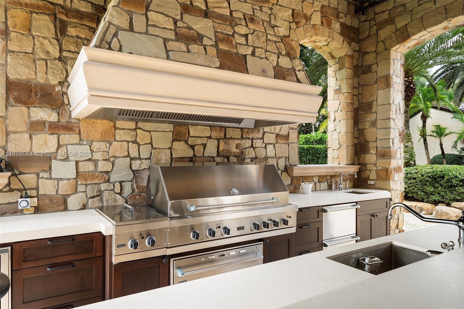 10101 Southwest 60th Court Pinecrest, FL 33156 - Photo 70 of 98 a kitchen with a stove and a sink