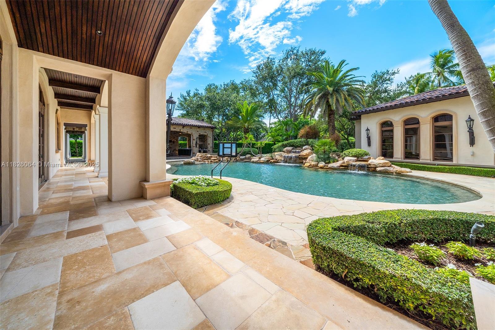 10101 Southwest 60th Court Pinecrest, FL 33156 - Photo 76 of 98 a front view of a house with a yard and potted plants