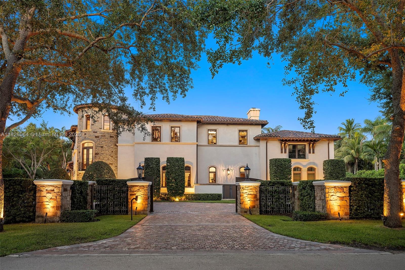 10101 Southwest 60th Court Pinecrest, FL 33156 - Photo 8 of 98 a front view of a house with a yard
