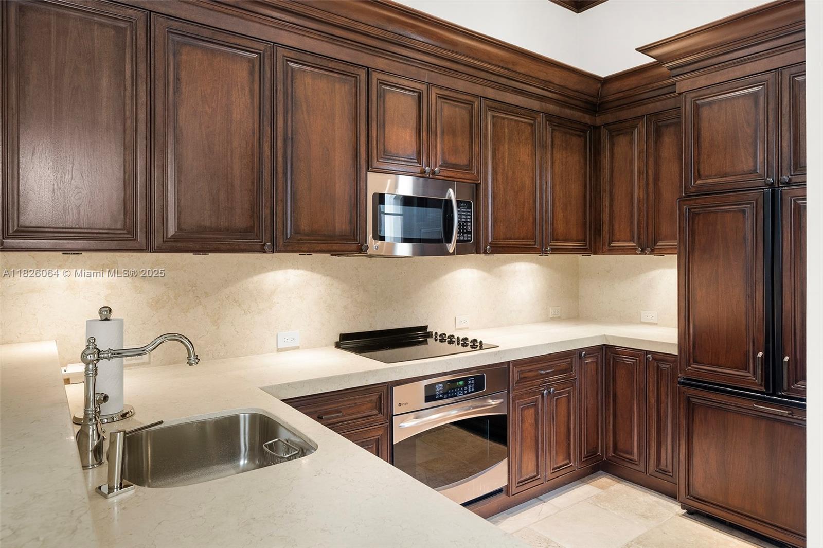 10101 Southwest 60th Court Pinecrest, FL 33156 - Photo 82 of 98 a kitchen with a stove and a sink