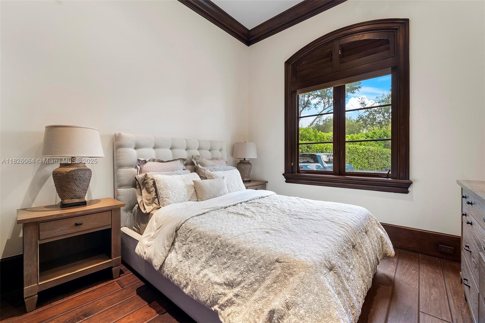 10101 Southwest 60th Court Pinecrest, FL 33156 - Photo 83 of 98 a bedroom with a bed and a window