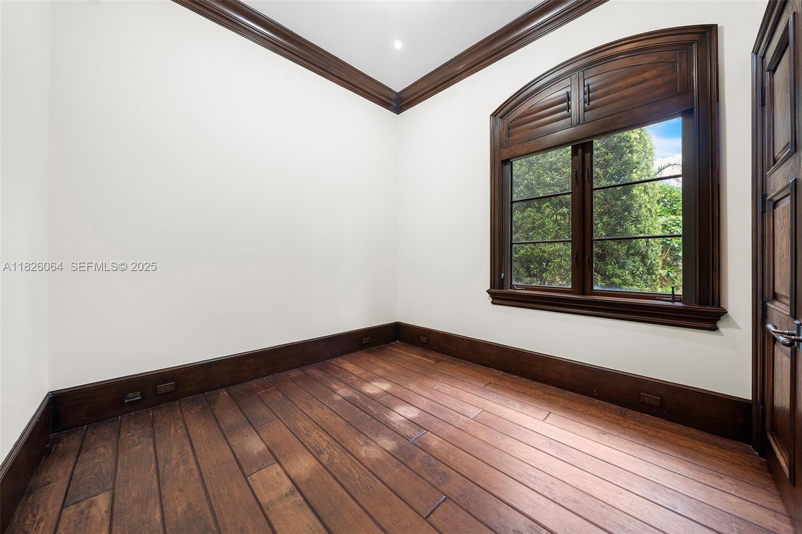 10101 Southwest 60th Court Pinecrest, FL 33156 - Photo 84 of 98 a view of a room with wooden floor and windows