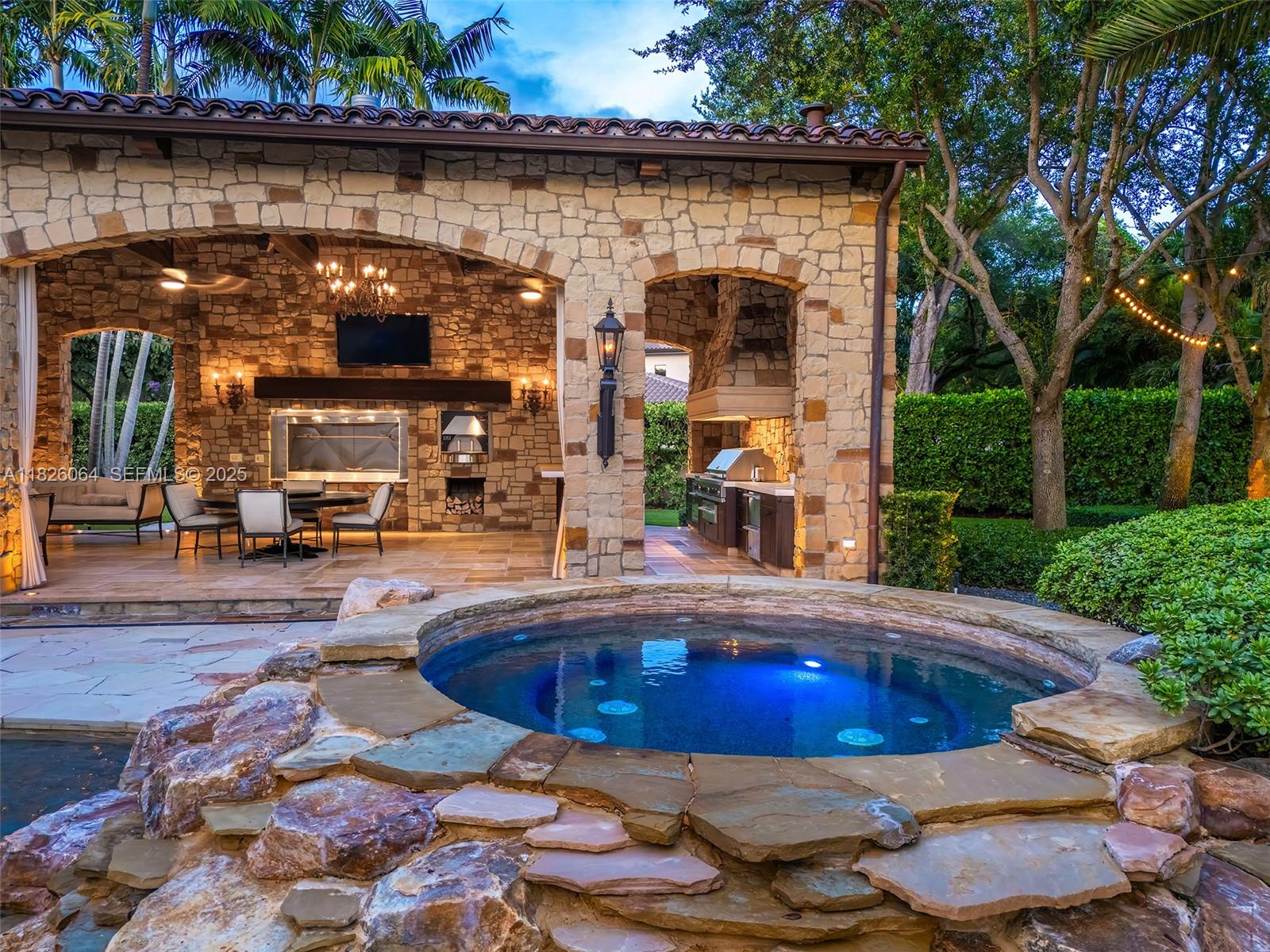 10101 Southwest 60th Court Pinecrest, FL 33156 - Photo 98 of 98 a swimming pool with outdoor seating