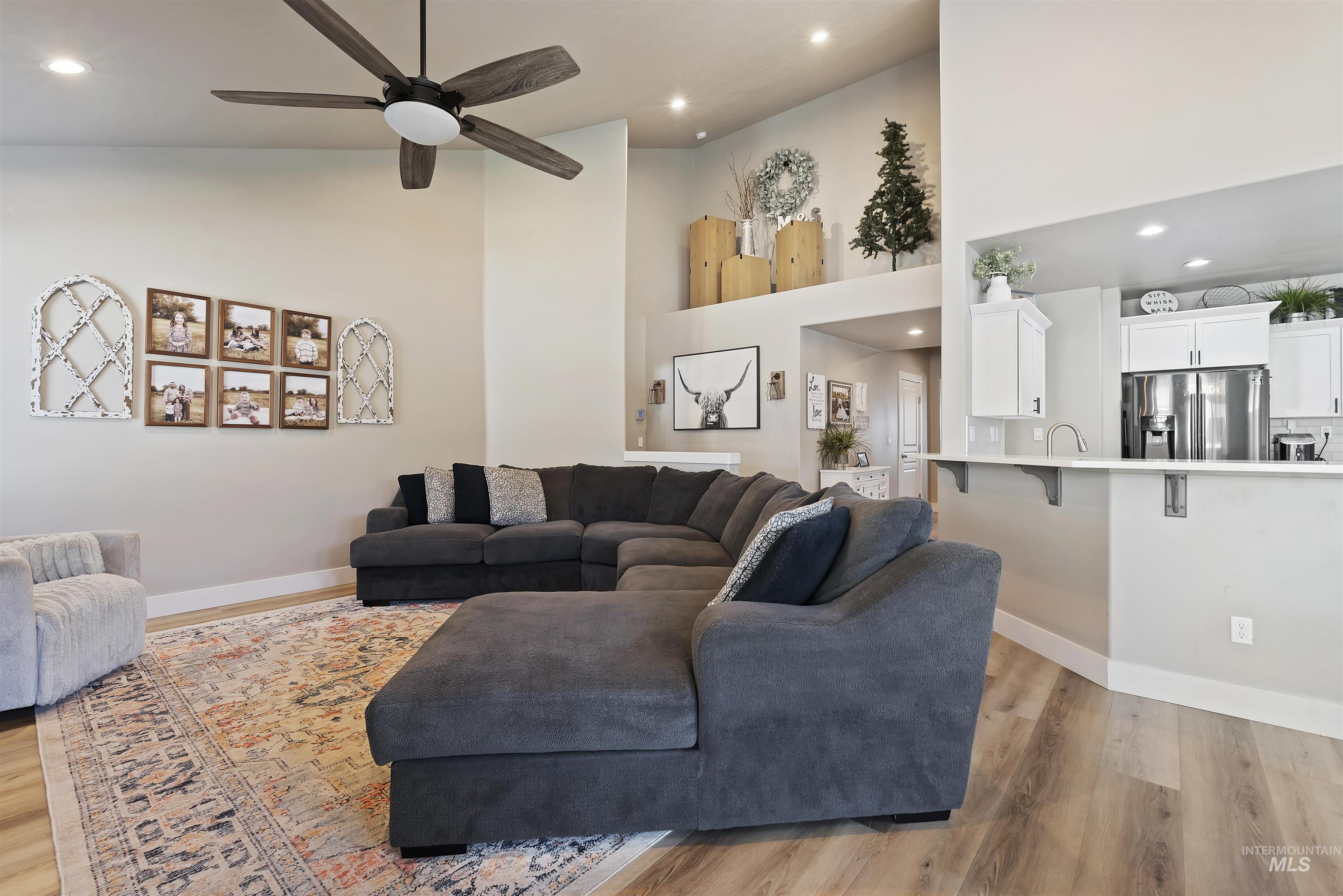 654 Diamond Lake Street Middleton, ID 83644 - Photo 14 of 36 Living area with a high ceiling, recessed lighting, light wood finished floors, and a ceiling fan