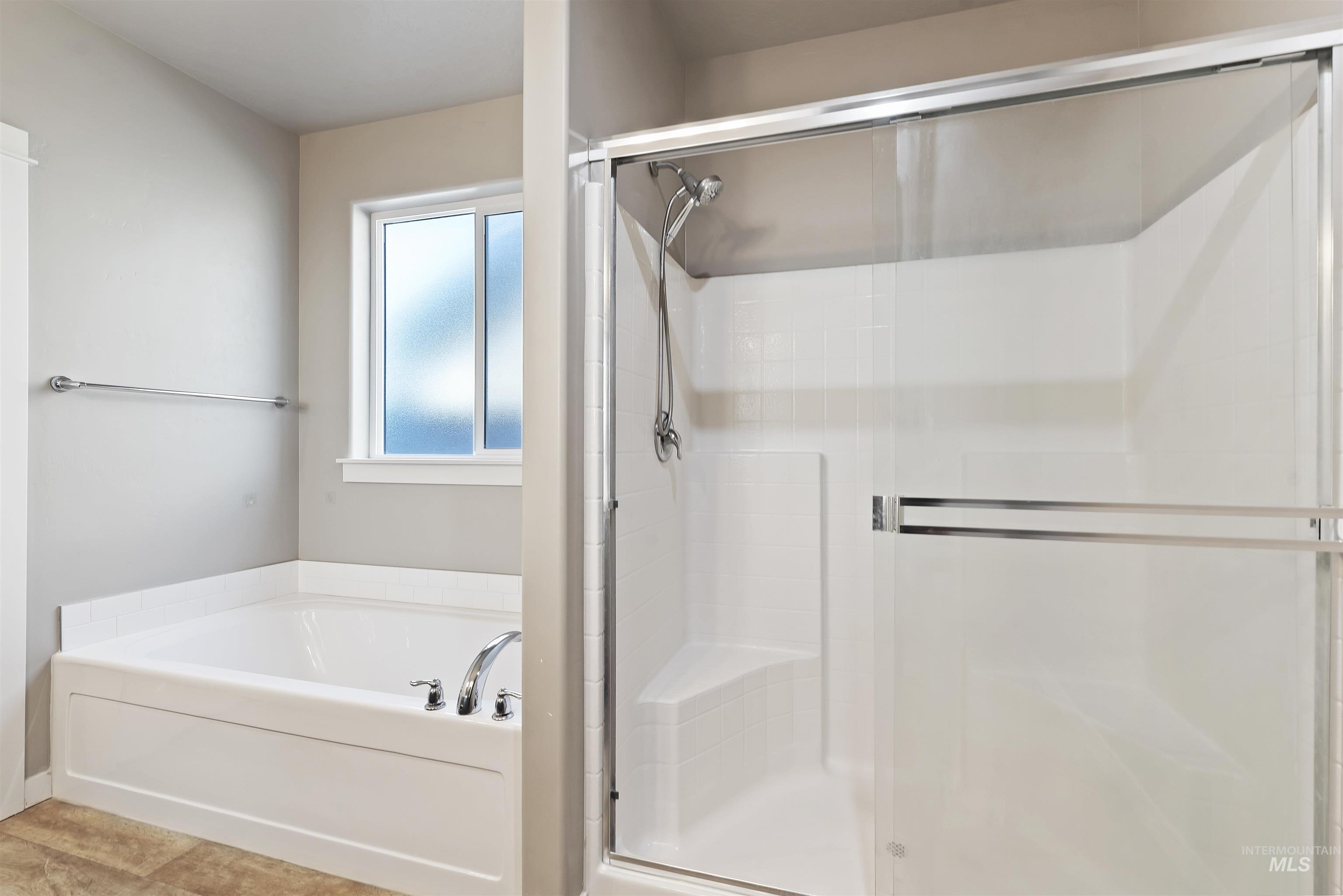 654 Diamond Lake Street Middleton, ID 83644 - Photo 18 of 36 Full bathroom featuring a stall shower and a soaking tub
