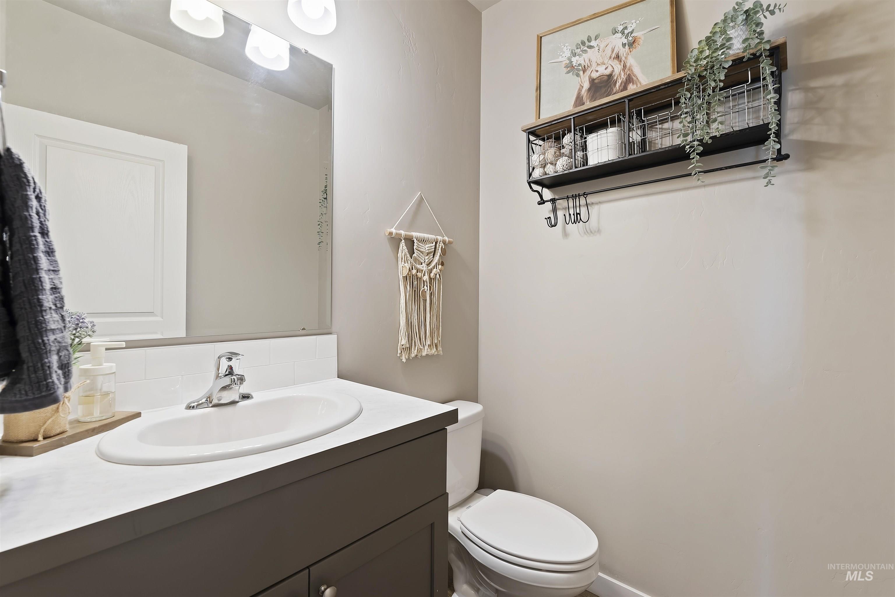 654 Diamond Lake Street Middleton, ID 83644 - Photo 21 of 36 Half bathroom with vanity and toilet