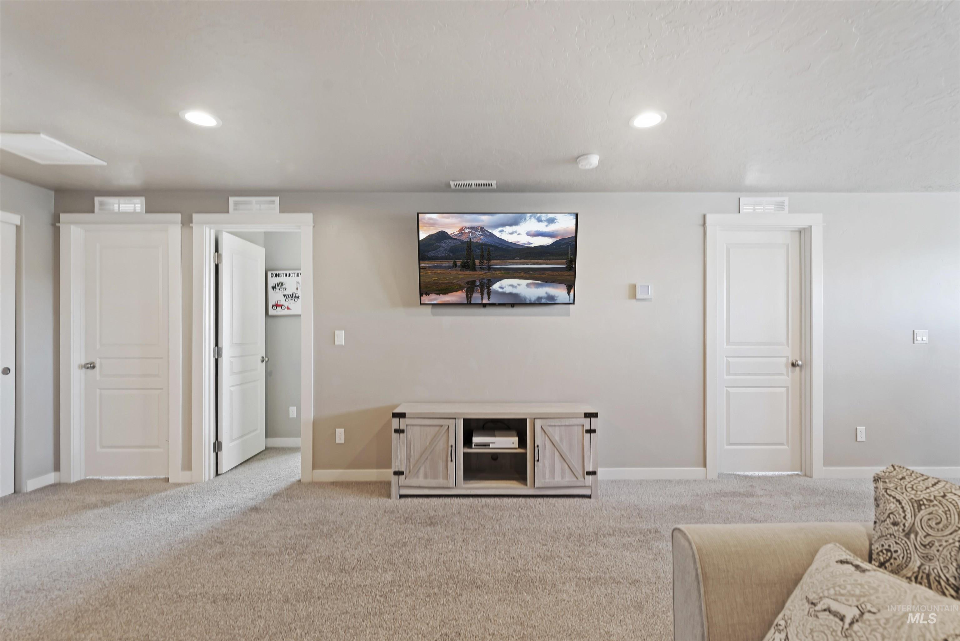 654 Diamond Lake Street Middleton, ID 83644 - Photo 24 of 36 Living area featuring light carpet and recessed lighting and Wall mount TV