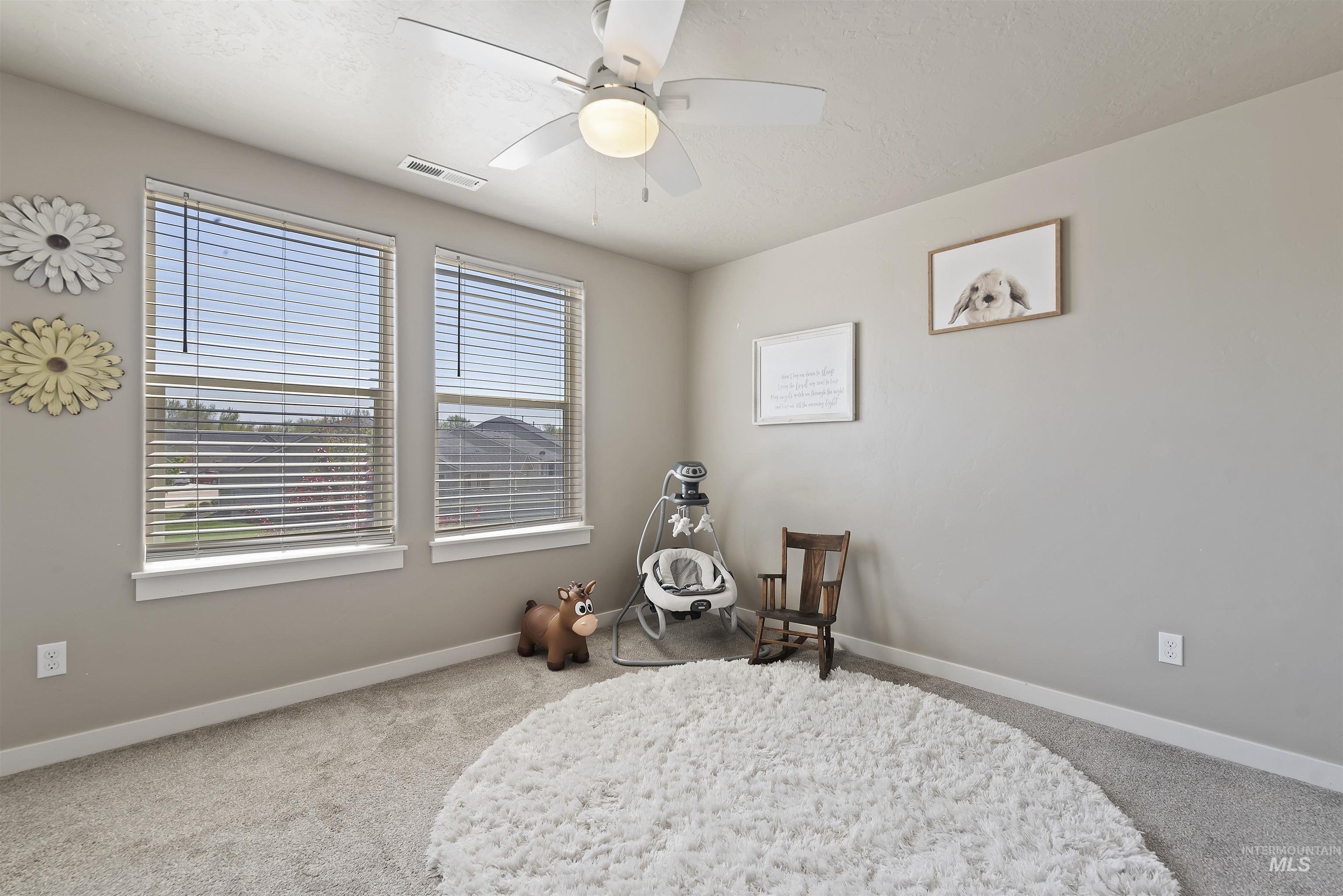 654 Diamond Lake Street Middleton, ID 83644 - Photo 25 of 36 Bedroom featuring ceiling fan and light carpet
