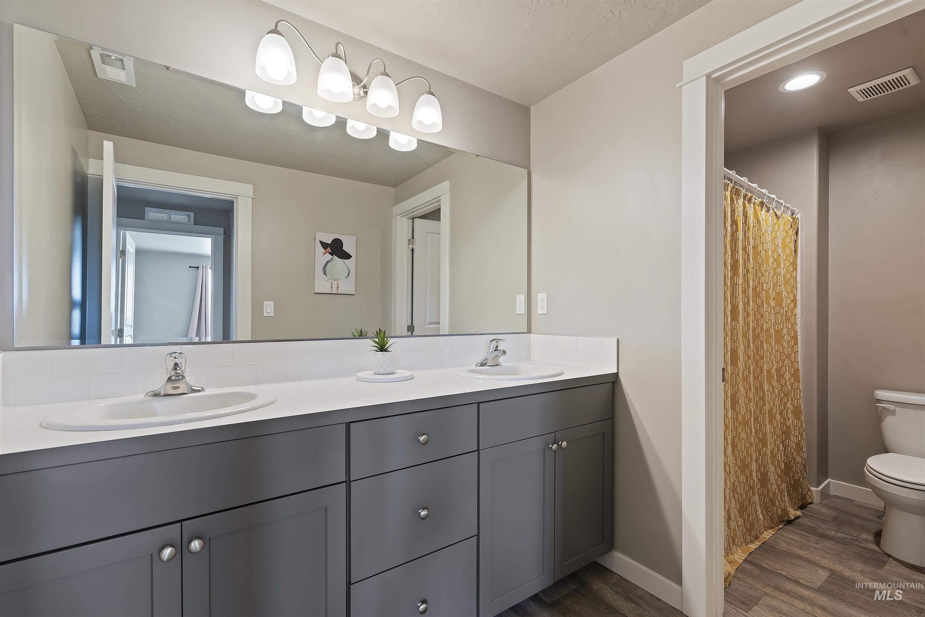 654 Diamond Lake Street Middleton, ID 83644 - Photo 29 of 36 Bathroom with double vanity and a separate shower and toilet room.