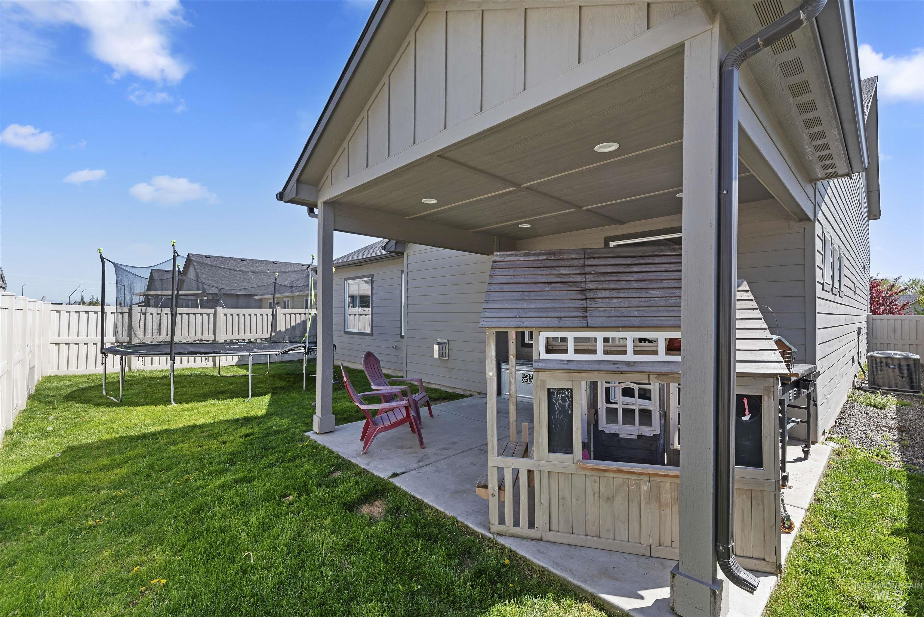 654 Diamond Lake Street Middleton, ID 83644 - Photo 30 of 36 Fenced backyard featuring a trampoline and covered patio