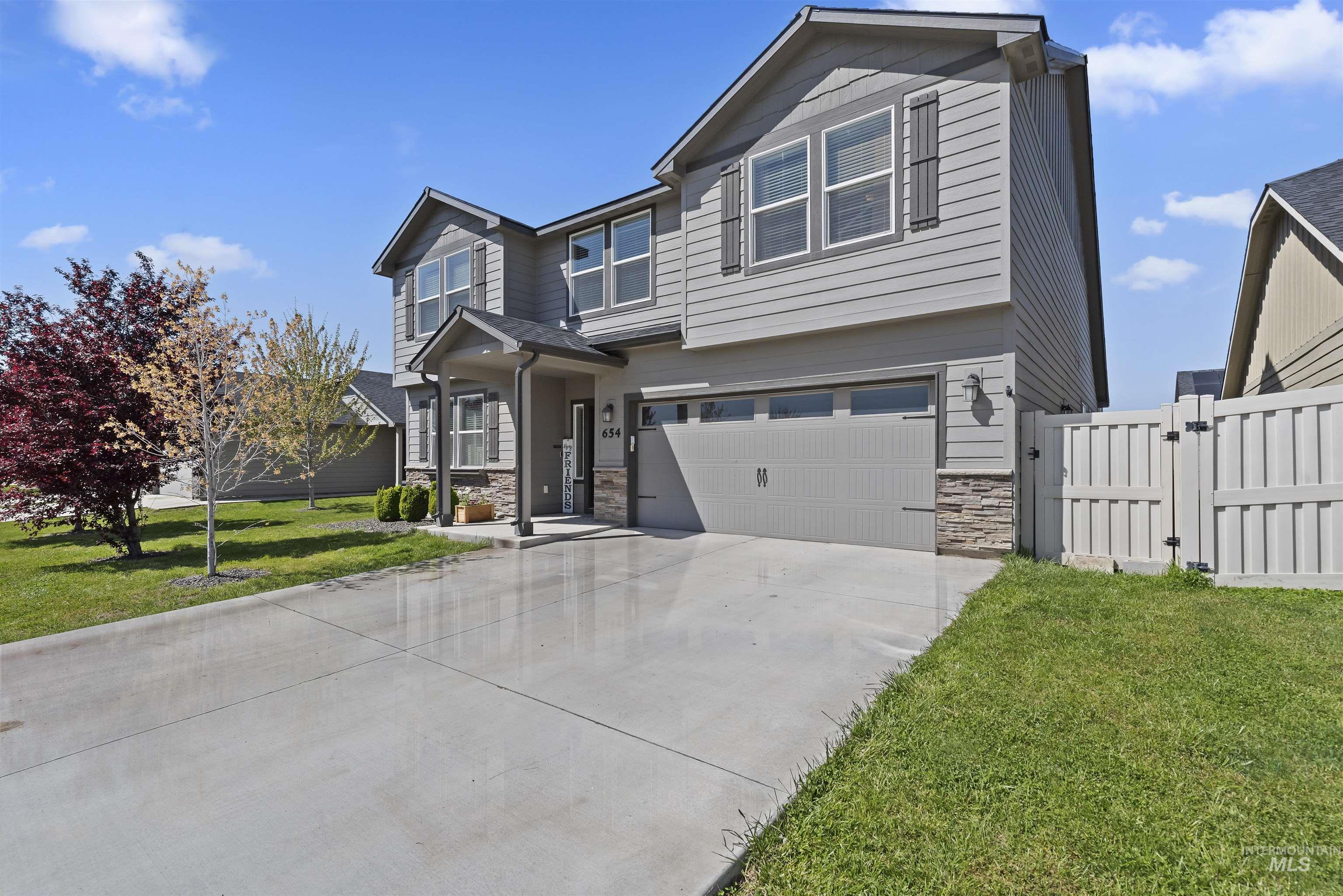 654 Diamond Lake Street Middleton, ID 83644 - Photo 33 of 36 View of front facade with stone, a gate, a two car garage, and concrete driveway