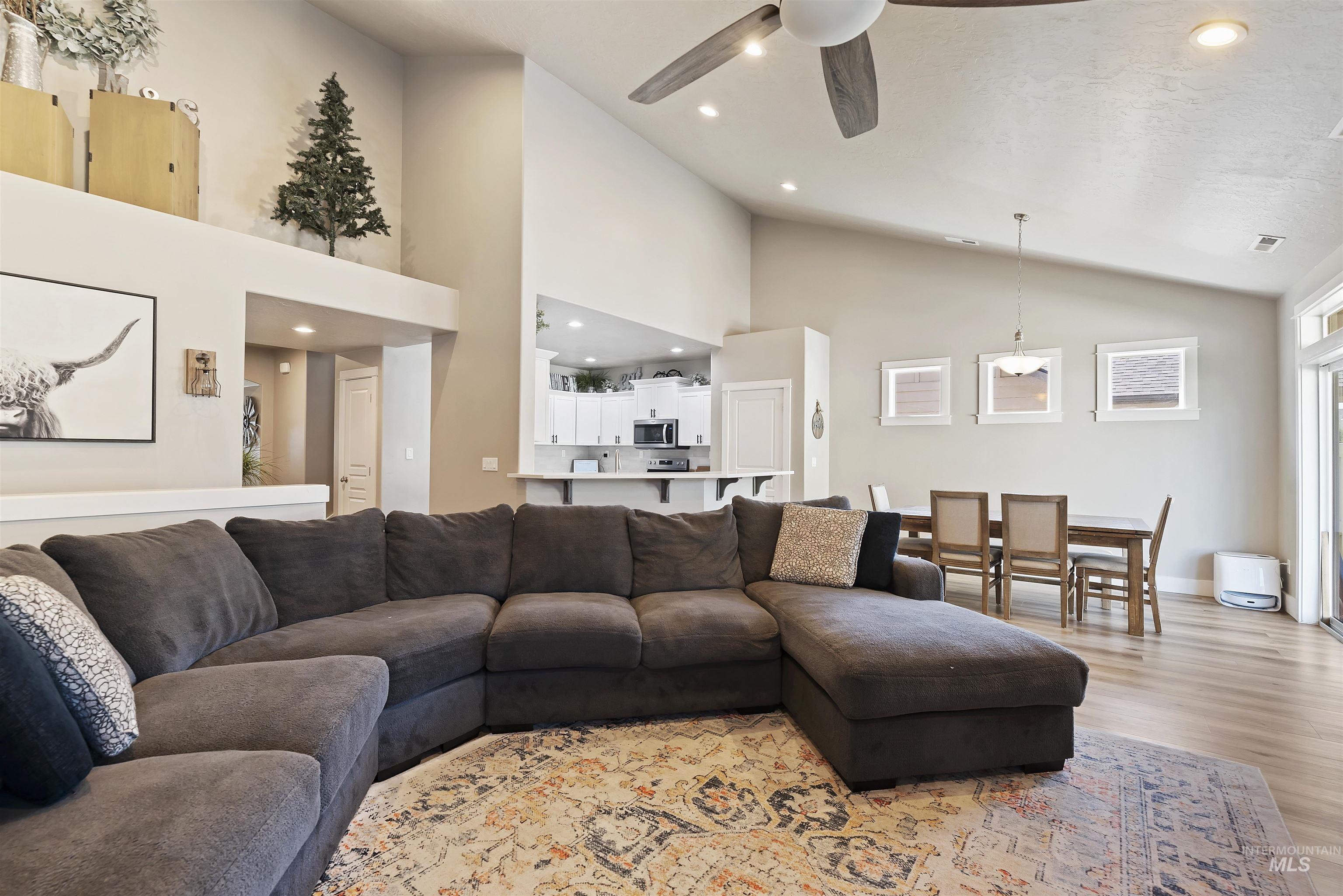 654 Diamond Lake Street Middleton, ID 83644 - Photo 8 of 36 Living area featuring recessed lighting, ceiling fan, light wood-style flooring, and lofted ceiling
