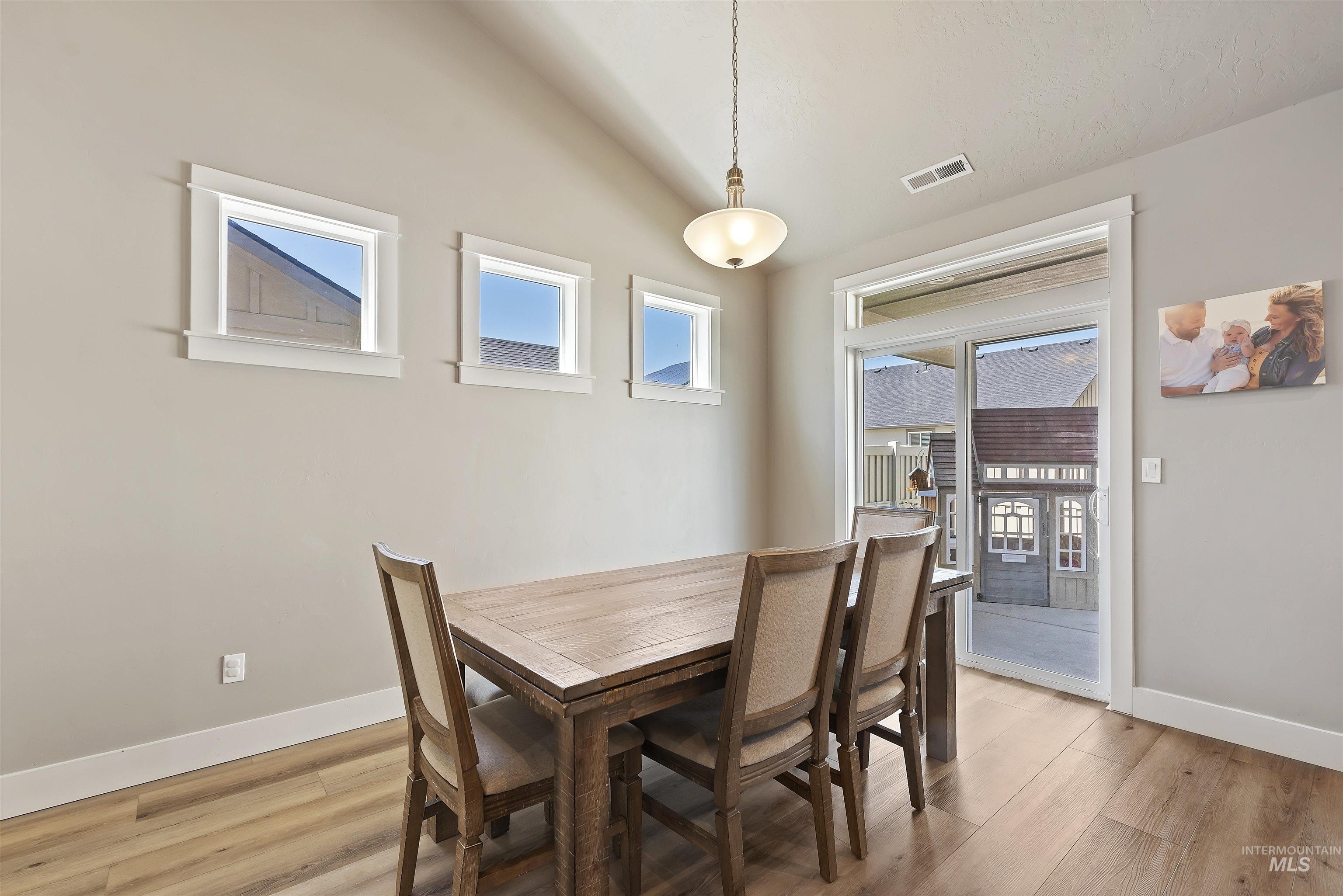 654 Diamond Lake Street Middleton, ID 83644 - Photo 9 of 36 Dining room with vaulted ceiling and light wood-style floors