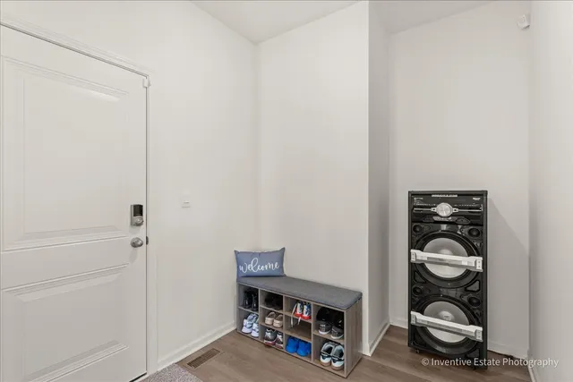 a view of livingroom with a wooden floor and shoes