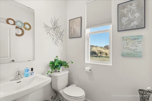 a bathroom with a toilet a sink and mirror