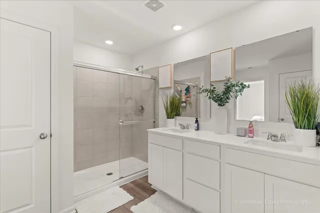 a bathroom with a shower sink and mirror