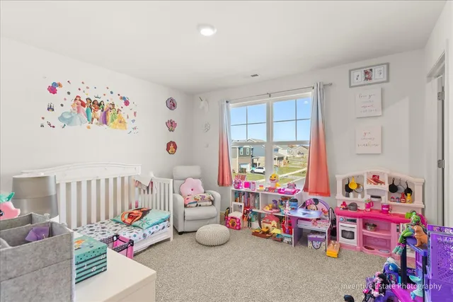 a bedroom with toys and a baby crib