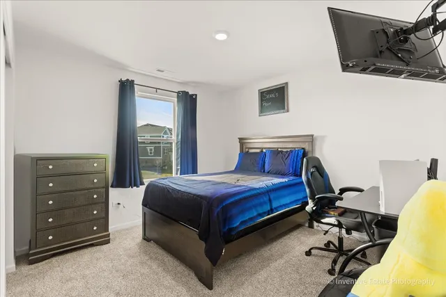 a bedroom with a bed and a dresser