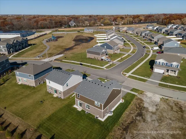 an aerial view of residential houses with outdoor space