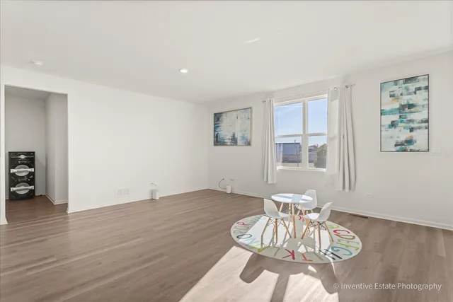 a view of a livingroom with wooden floor and a cabinet