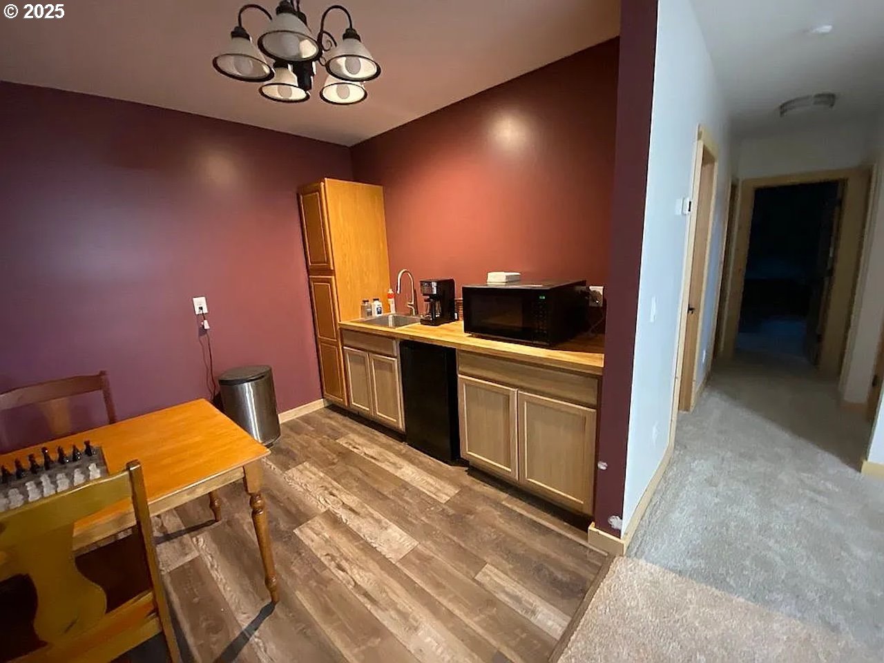 55778 Southwest Scoggins Valley Road Gaston, OR 97119 - Photo 13 of 42 a kitchen with a chandelier appliances and cabinets
