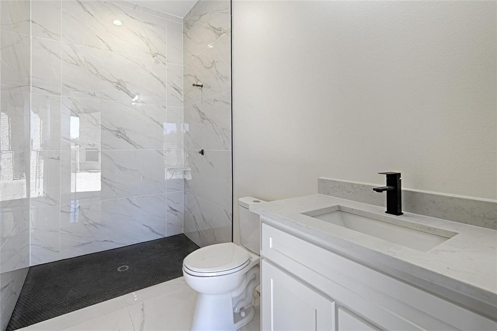 3611 Jacks Loop Midlothian, TX 76065 - Photo 17 of 39 a bathroom with a granite countertop sink a toilet and shower