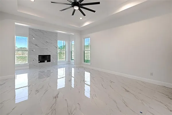 a view of a livingroom with a ceiling fan and window