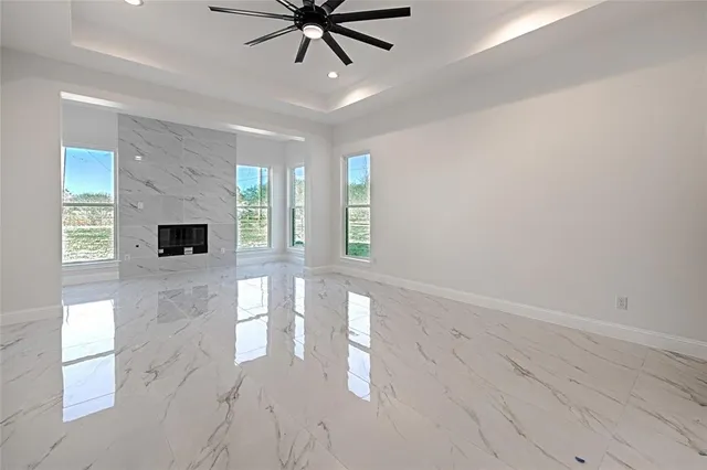 a view of a livingroom with a ceiling fan and window