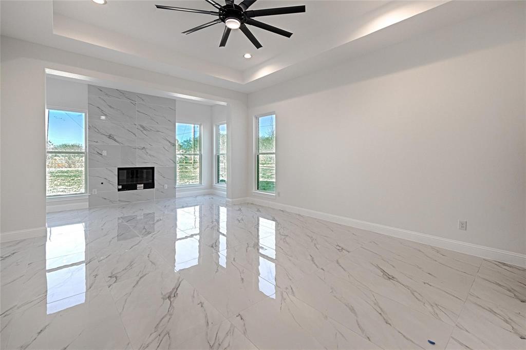 3611 Jacks Loop Midlothian, TX 76065 - Photo 18 of 39 a view of a livingroom with a ceiling fan and window