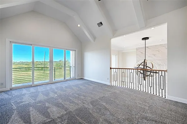 a view of a livingroom with a ceiling fan and window