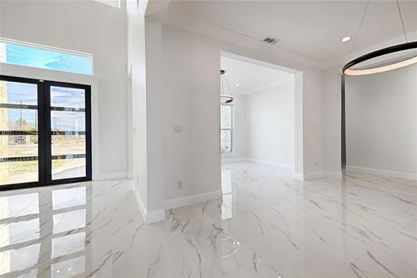 view of empty room with windows and wardrobe