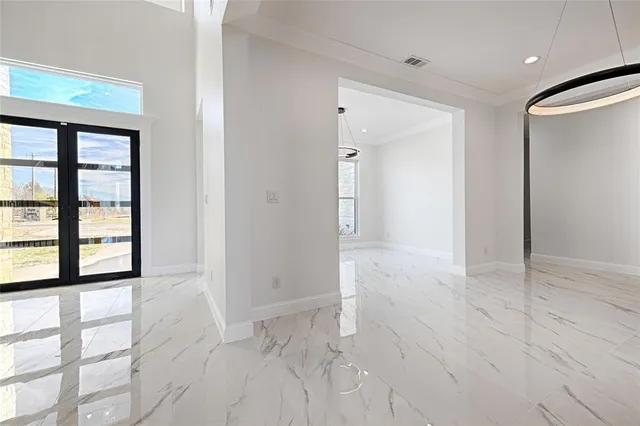 view of empty room with windows and wardrobe
