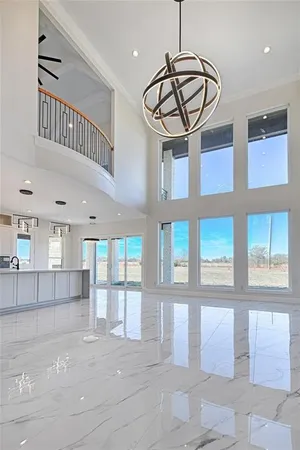 a view of a hallway with entryway window and chandelier
