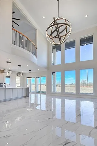 a view of a hallway with entryway window and chandelier