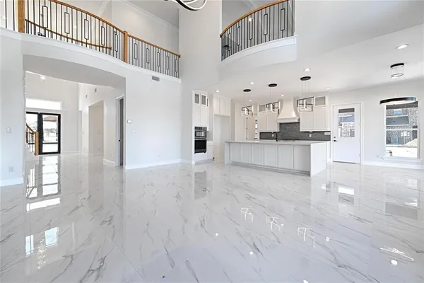 a large kitchen with cabinets and wooden floor