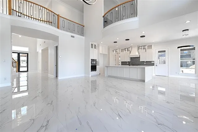 a large kitchen with cabinets and wooden floor