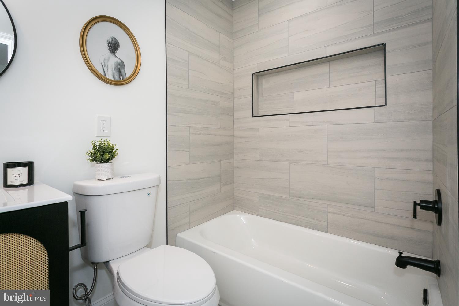 3729 Beehler Avenue Baltimore, MD 21215 - Photo 18 of 36 a bathroom with a toilet a sink and a bathtub