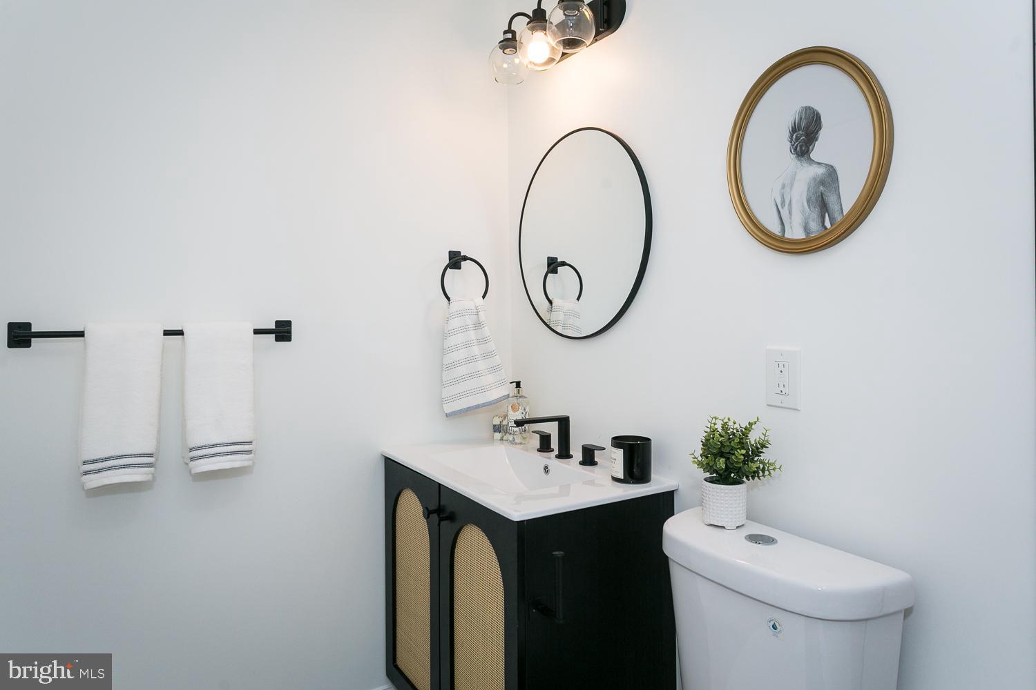 3729 Beehler Avenue Baltimore, MD 21215 - Photo 19 of 36 a bathroom with a toilet sink and mirror