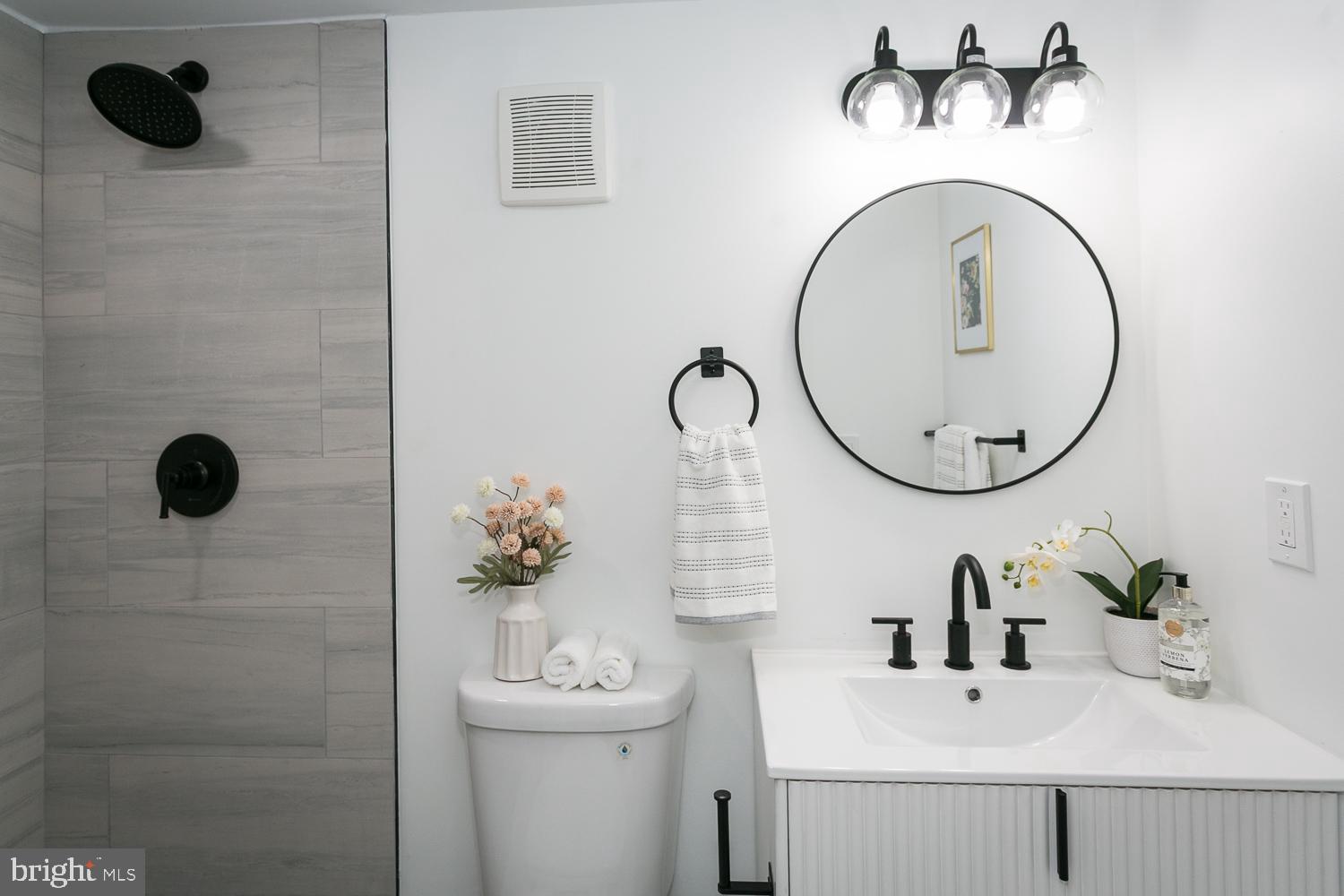 3729 Beehler Avenue Baltimore, MD 21215 - Photo 20 of 36 a bathroom with a sink a toilet and a mirror